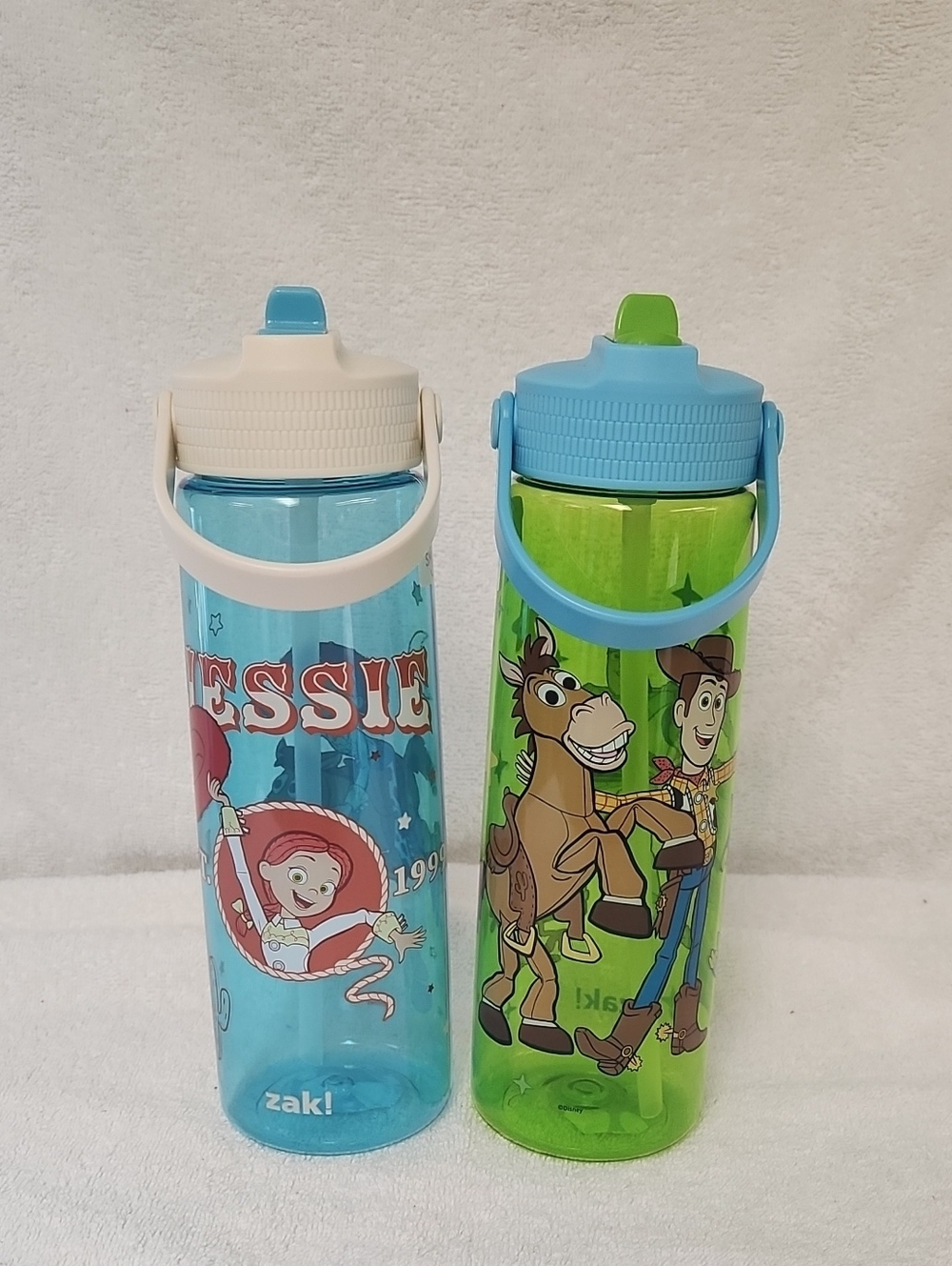 2 Kids' Toy Story Woody And Jessie Flip-Spout Water Bottles — Blue and Green